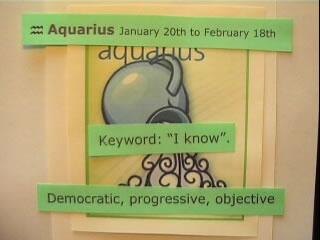 Signo de zodiaco (Aquarius) con carteles de texto encima (democr�tic, progressive..)